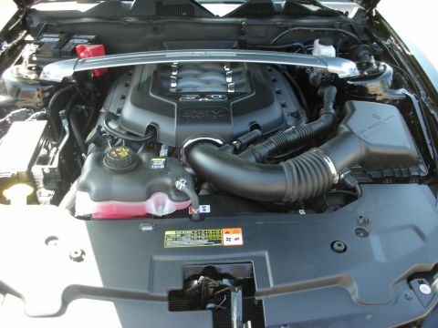 1992 Ford Crown Victoria - The engine bay of a vehicle, a 5.0 V8 engine cover and associated intake components.