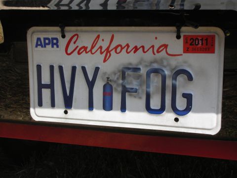 1992 Ford Crown Victoria - This California license plate has the custom text 'HVY FOG' and includes a graphic of a small tank and smoke.