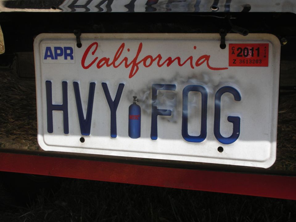 California license plate reading HVY FOG with a small blue tank and smoke graphic