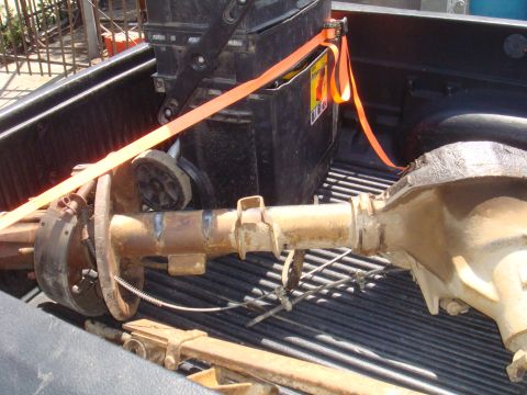 1992 Ford Bronco - Rear axle assembly being transported in the bed of a pickup truck.