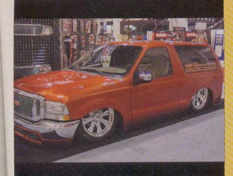 1995 Ford Bronco - This orange SUV features custom wheels and a lowered stance, suggesting a modified vehicle from around 2005.