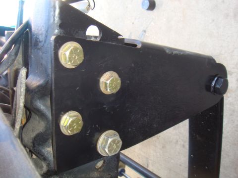 1992 Ford Bronco - Close-up of a black metal bracket with multiple bolts attached.