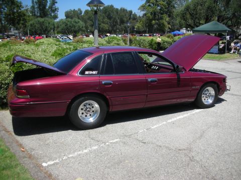 1992 Ford Crown Victoria - This maroon 1992 Ford Crown Victoria is displayed with its hood and trunk open, drag-style wheels.
