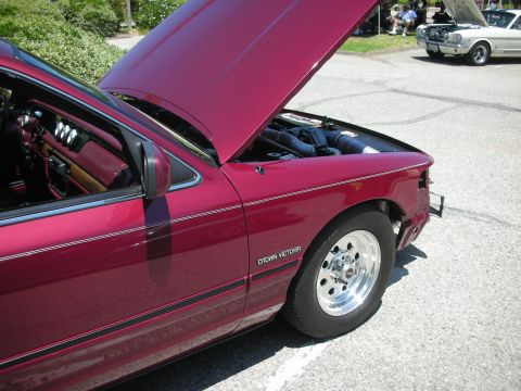 1992 Ford Crown Victoria - Maroon 1992 Ford Crown Victoria at a car show with its hood up.