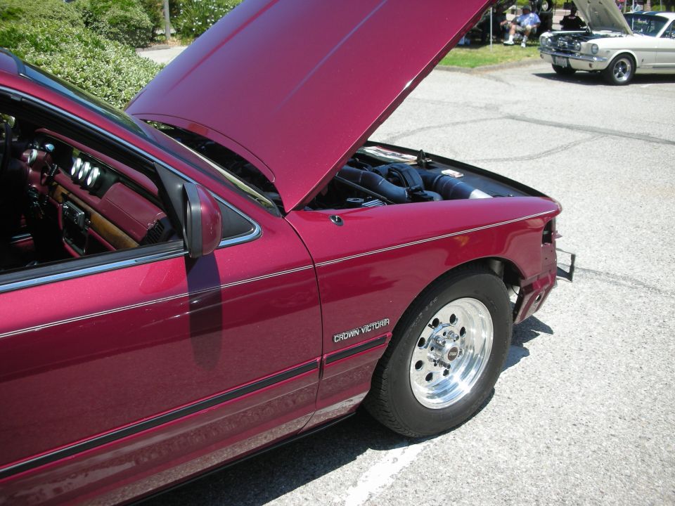 Maroon 1992 Ford Crown Victoria with hood open, showing engine bay. Another car is visible in the background