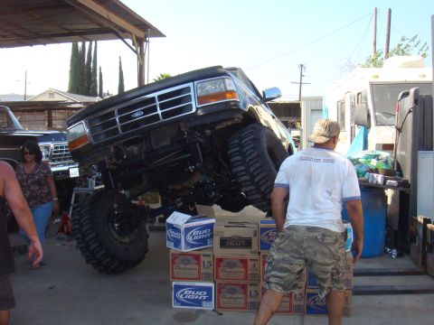1992 Ford Bronco - A heavily modified Ford truck is precariously balanced on stacks of beer cases.