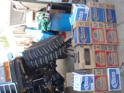 1992 Ford Bronco - Vehicle parts and cases of beer stacked together.