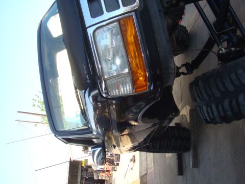 1992 Ford Bronco - Front view of a 1992 Ford Bronco modified with large off-road tires.