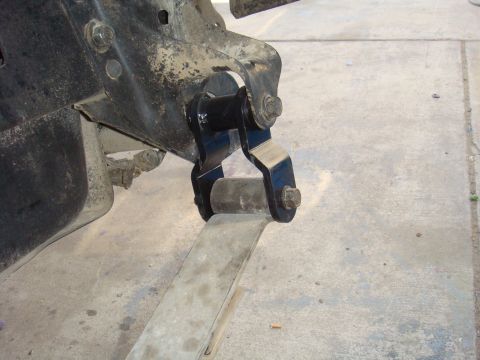 1992 Ford Bronco - Close-up of a vehicle's leaf spring and shackle mount assembly.