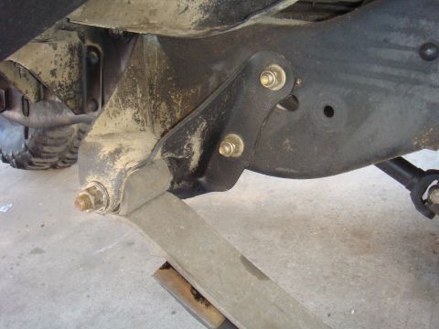 1992 Ford Bronco - This image shows a close-up view of a vehicle's suspension system, focusing on the leaf spring attachment point.