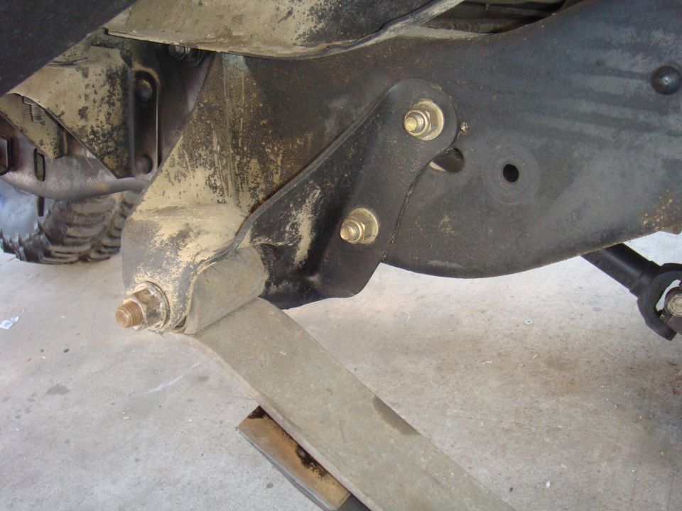 close-up of a vehicle's leaf spring mount and suspension components