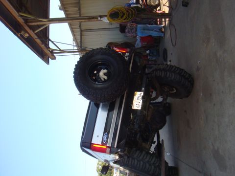 1992 Ford Bronco - This 1992 Ford Bronco is equipped with oversized tires and a spare tire on the back.