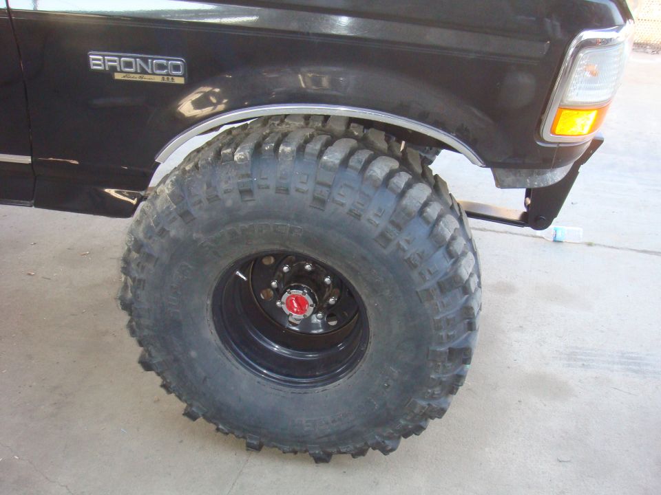 Black 1992 Ford Bronco side view with large off-road tires and "BRONCO" badge