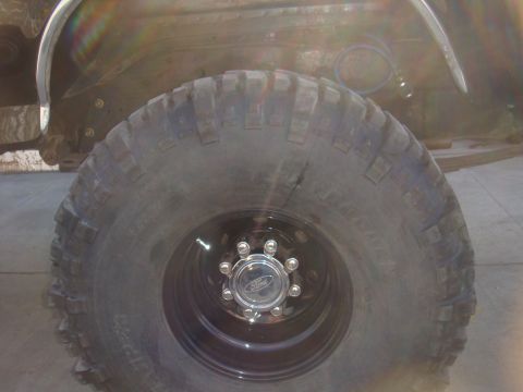 1992 Ford Bronco - Close-up of the front wheel and fender of a 1992 Ford Bronco.