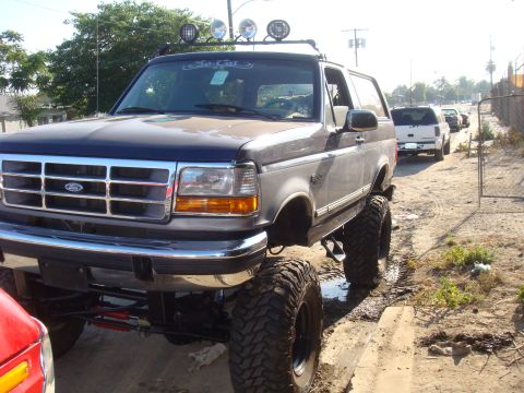 1992 Ford Bronco - This lifted 1992 Ford Bronco features oversized tires and a prominent grille.