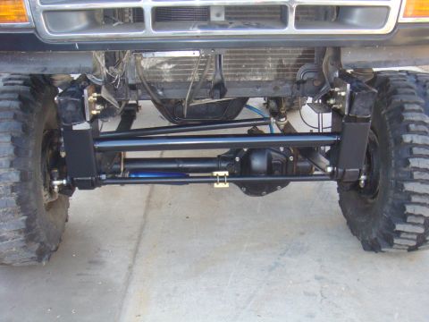 1992 Ford Bronco - Close-up view of modified front axle and suspension components on a vehicle.