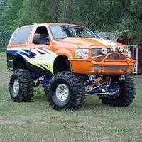 1995 Ford Bronco - This heavily modified Ford Bronco features a lifted suspension, large off-road tires, and custom graphics.