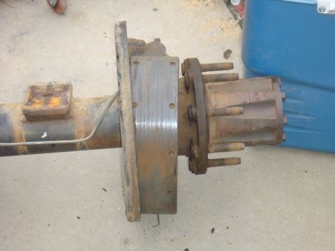 1992 Ford Bronco - Close-up of a vehicle's rear axle assembly, including brake components and hub.