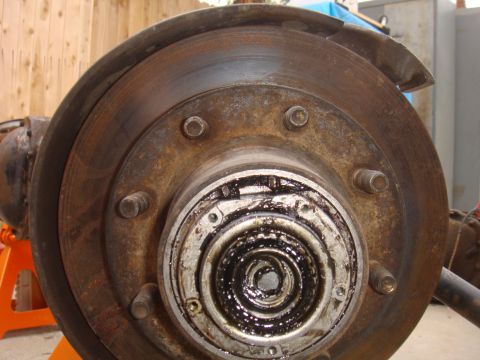 1992 Ford Bronco - Close-up of a rusty front wheel hub and brake rotor assembly, likely from a truck or SUV.
