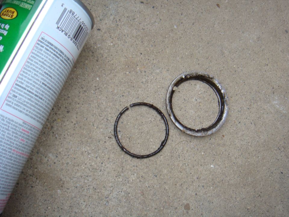 Worn axle seals and a can of spray paint on concrete