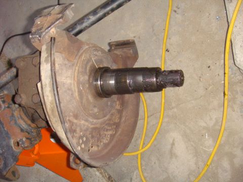 1992 Ford Bronco - Vehicle axle assembly with splined shaft, on an orange jack stand.