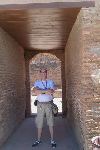 1991 Ford LTD Crown Victoria - A man stands in an arched brick passageway, with a wooden ceiling overhead and rough brick walls.