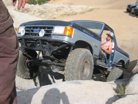 1989 Ford Bronco - This heavily modified Ford Bronco is navigating a rocky off-road course.