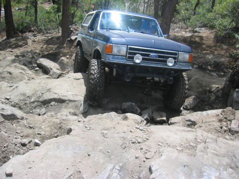 1989 Ford Bronco - This 1989 Ford Bronco tackles a challenging off-road course with large rocks and steep inclines.