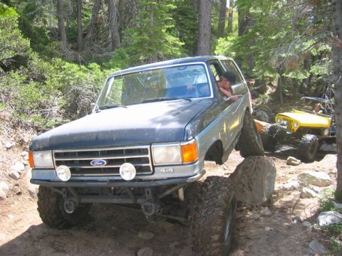 1989 Ford Bronco - This 1989 Ford Bronco is shown off-roading on a rocky trail with another vehicle following.