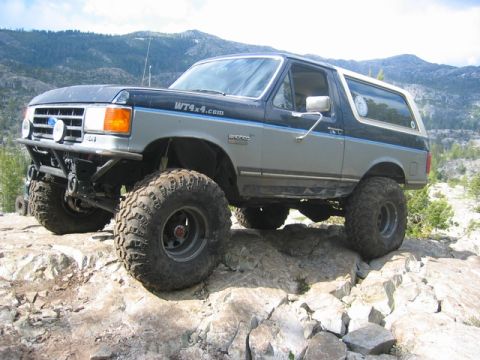 1989 Ford Bronco - This modified Ford Bronco navigates a challenging rocky landscape.