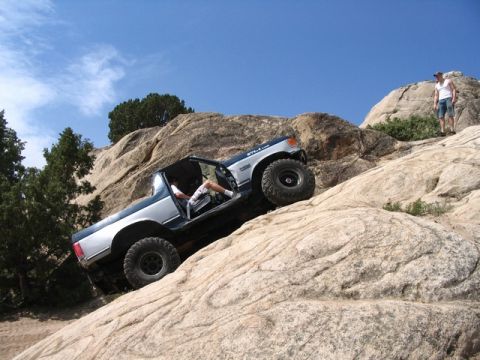 1989 Ford Bronco - 1989 Ford Bronco navigating a challenging rocky terrain.