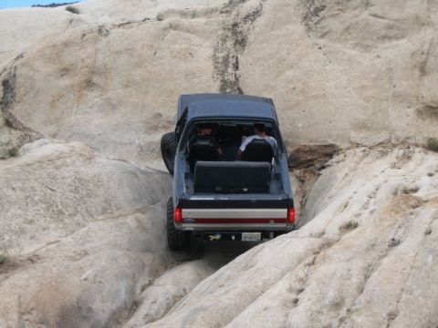 1989 Ford Bronco - A 1989 Ford Bronco tackles a challenging rocky terrain during an off-road excursion.