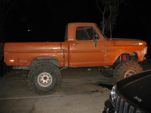 1969 Ford F-250 - This lifted pickup truck features oversized tires and a raised suspension, giving it an aggressive stance.