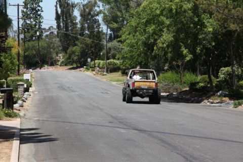 1989 Ford Bronco - This 1989 Ford Bronco is seen from the rear, driving down a residential road.