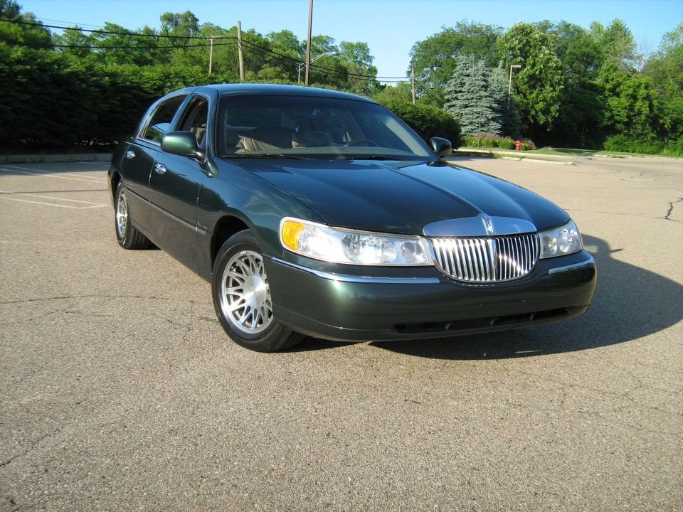 Dark green sedan's front grille and headlights