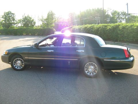 1988 Mercury Grand Marquis - This dark green sedan, viewed from the side, appears to be a 2001 model year vehicle.