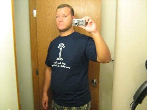 1988 Mercury Grand Marquis - A man takes a selfie in a bathroom mirror, holding up a digital camera.