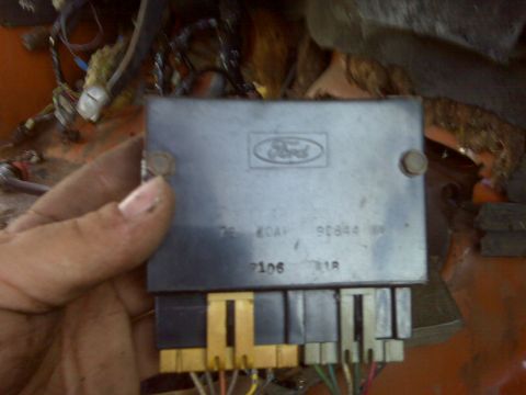 1969 Ford F-250 - A hand holds a Ford electronic control module, showing part numbers and connectors.