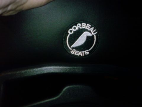 1995 Ford Bronco - A circular patch with the Corbeau Seats logo is visible on dark material, possibly a car seat.