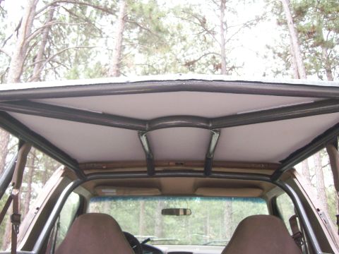 1993 Ford Bronco - Custom roll cage installed inside a vehicle's interior.