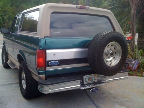 1996 Ford Bronco - This 1996 Ford Bronco features a two-tone paint scheme and a rear-mounted spare tire, visible from the back.