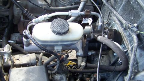 1996 Ford Bronco - This image shows a vehicle's brake master cylinder and associated plumbing, not a 1996 Ford Bronco.