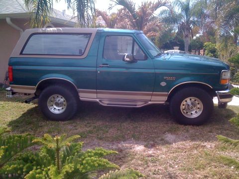 1996 Ford Bronco - This 1996 Ford Bronco is shown from the side in a grassy yard.