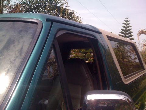 1996 Ford Bronco - The side profile of a 1996 Ford Bronco is visible, with a focus on the door and window area.