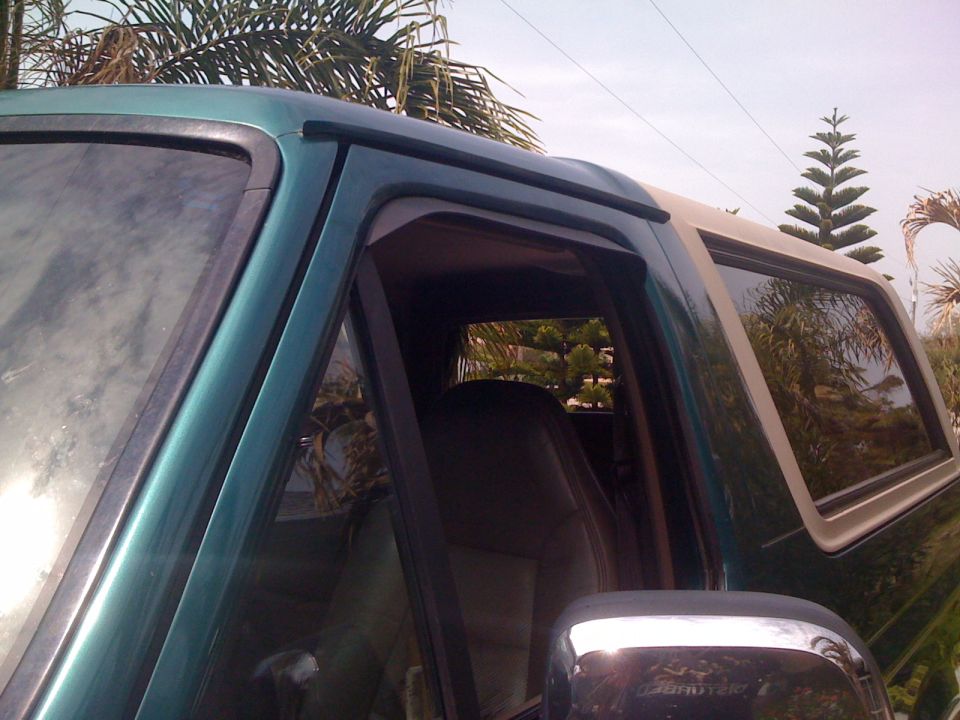 Side view of a 1996 Ford Bronco, showing the front door and rear passenger window