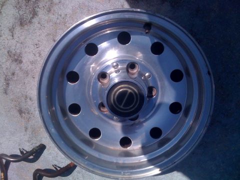 1996 Ford Bronco - A single chrome wheel is shown, with a black center cap displaying a D logo.