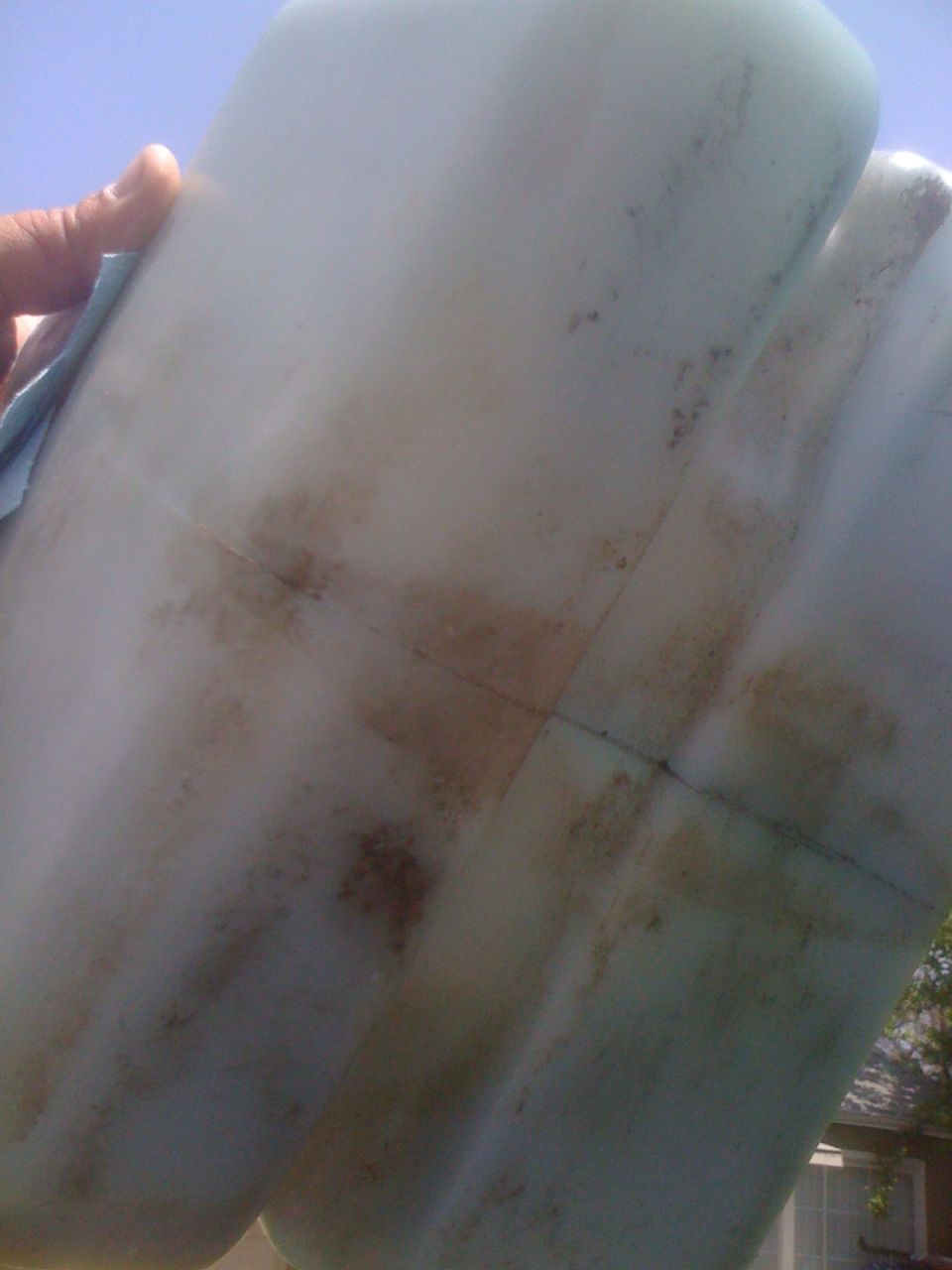 hand cleaning stained plastic tank