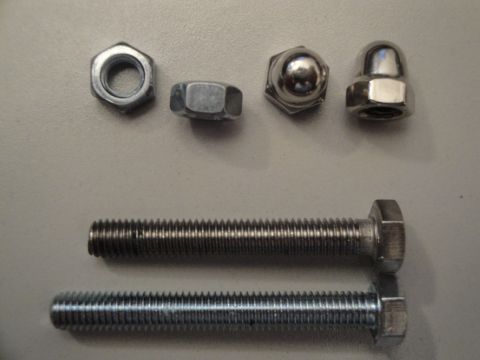 1993 Ford Taurus - A collection of fasteners, including hex bolts and nuts, are displayed on a neutral background.