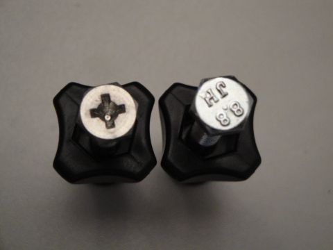 1993 Ford Taurus - Close-up of two black knobs, one with a screw and one with a hex bolt showing markings.