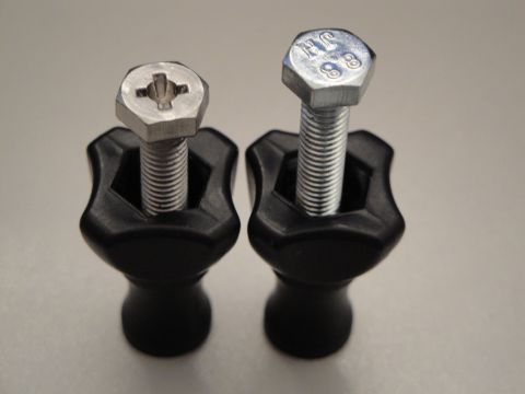 1993 Ford Taurus - Close-up of two black knobs with bolts, one with a Phillips head and the other a hex head marked JH 8.8.